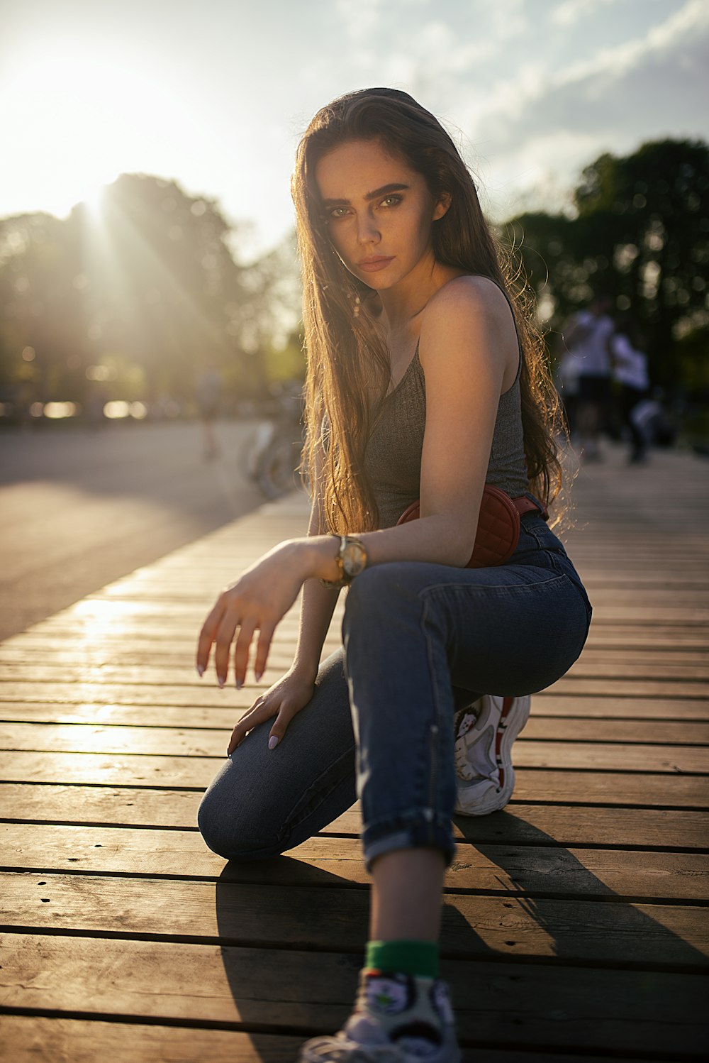 woman sitting on brown wooden bench