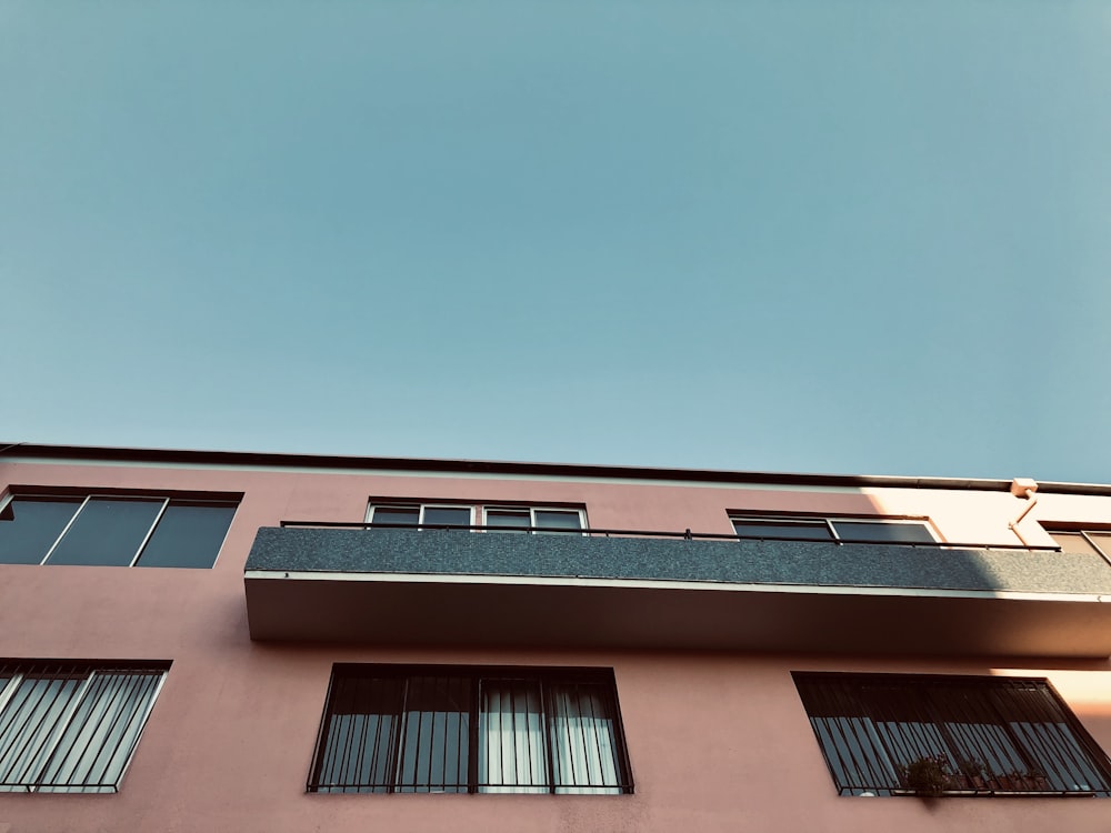 beige cement building with balcony