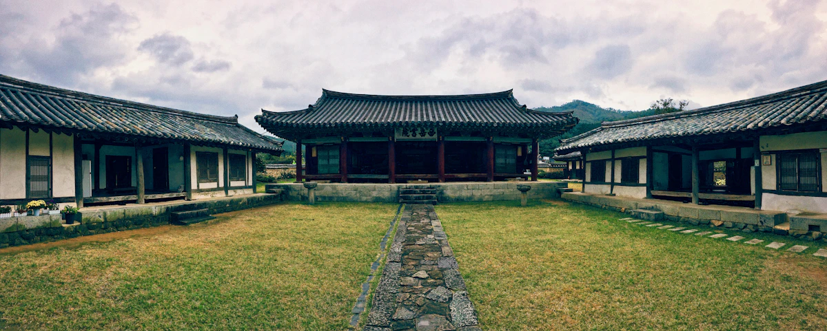 Traditional Korean hanok buildings framing a grass courtyard
