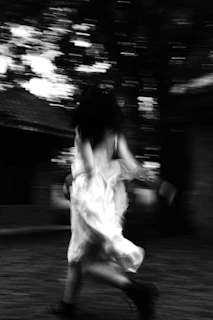 Dynamic motion blur of a runner sprinting on a treadmill with glowing purple highlights around.