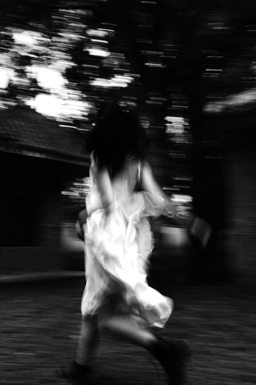 a blurry photo of a woman in a white dress