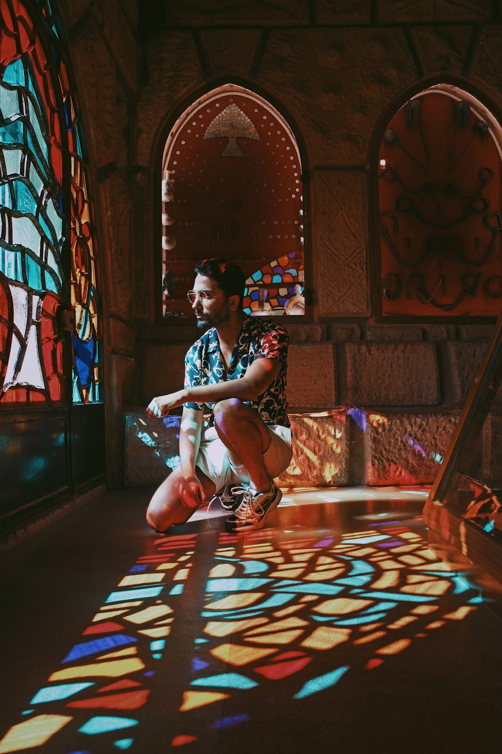 man beside stained glass windows