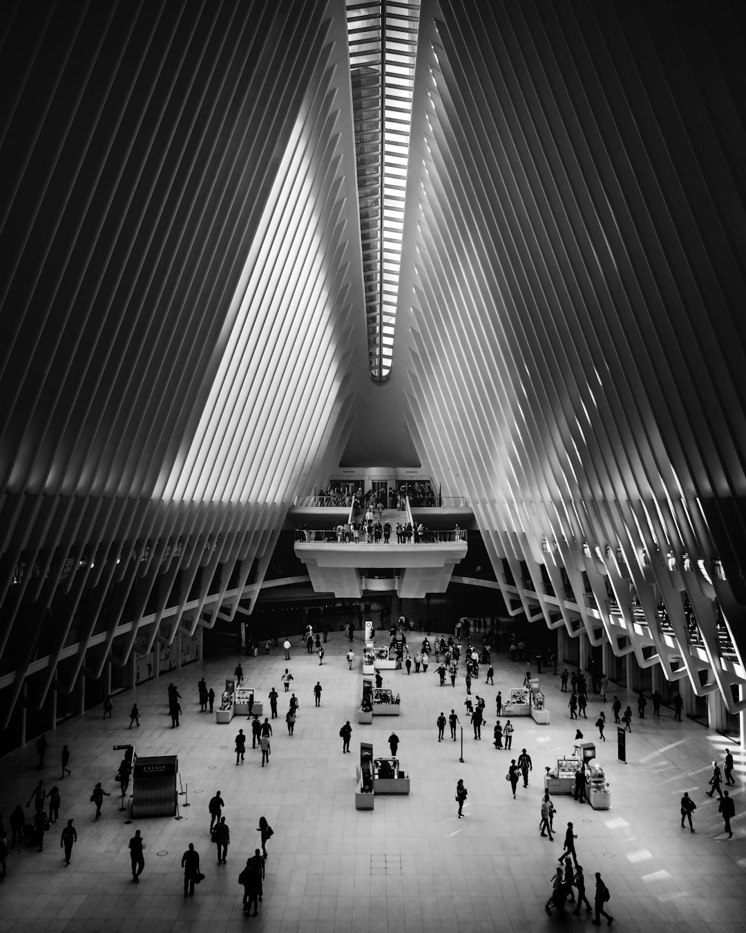 grayscale photography of people inside building