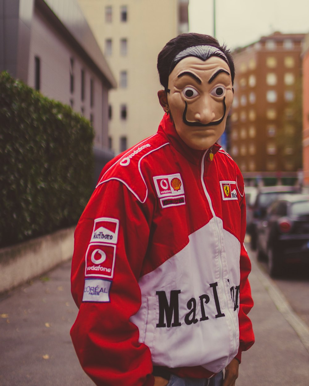 selective focus photography of man wearing mask and red and white jacket