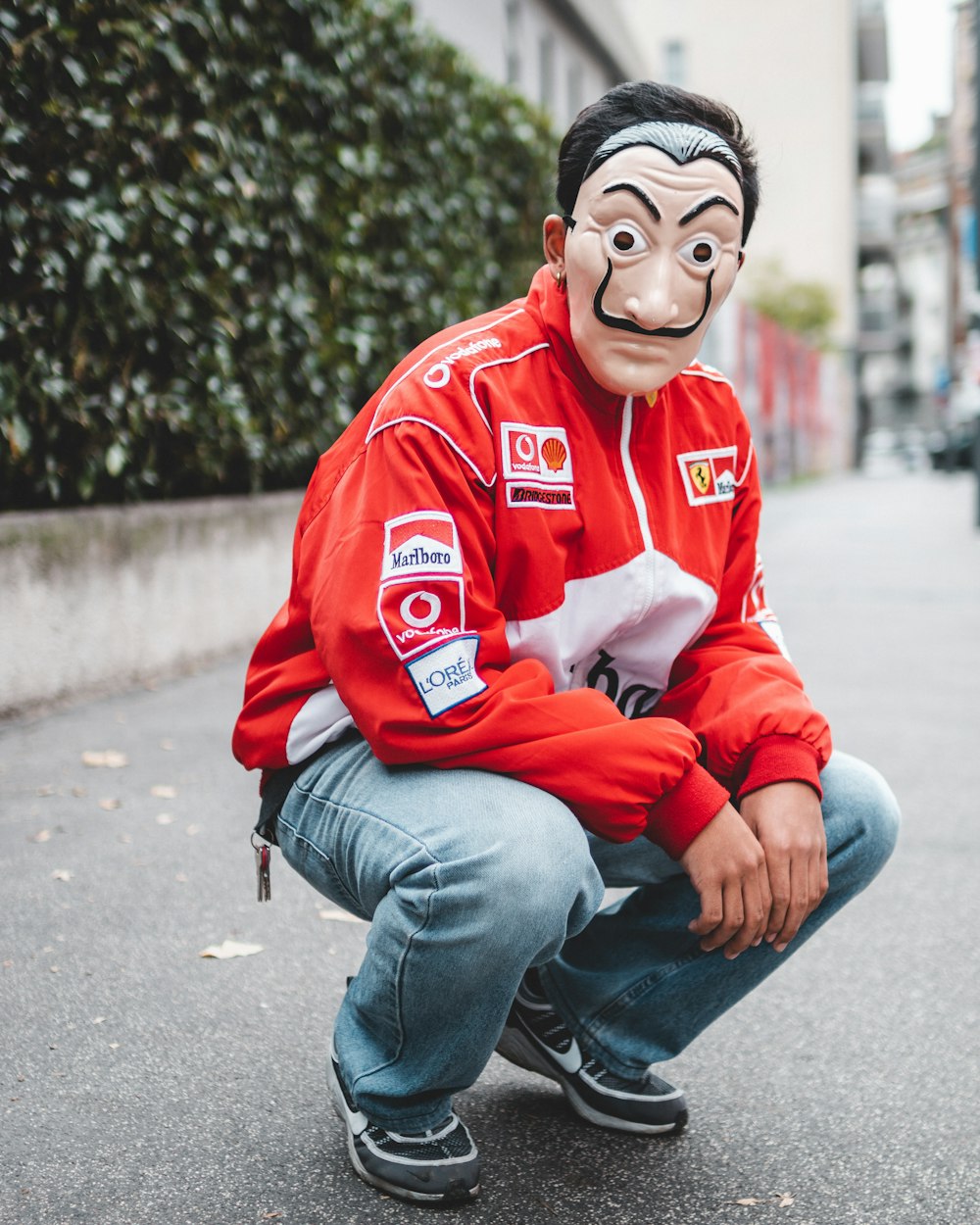 selective focus photography of man wearing mask and red and white jacket