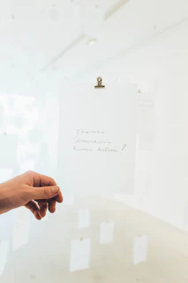 A close-up of a handwritten note with clear, simple words under a warm light.