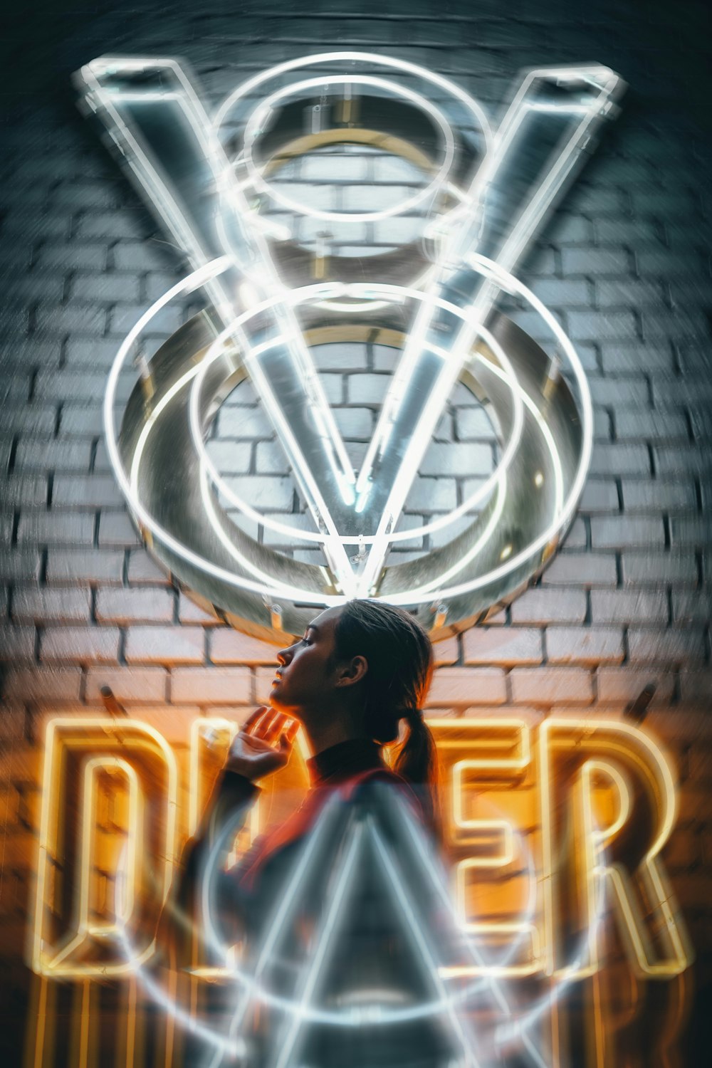 woman standing in front V8 Diner neon sign