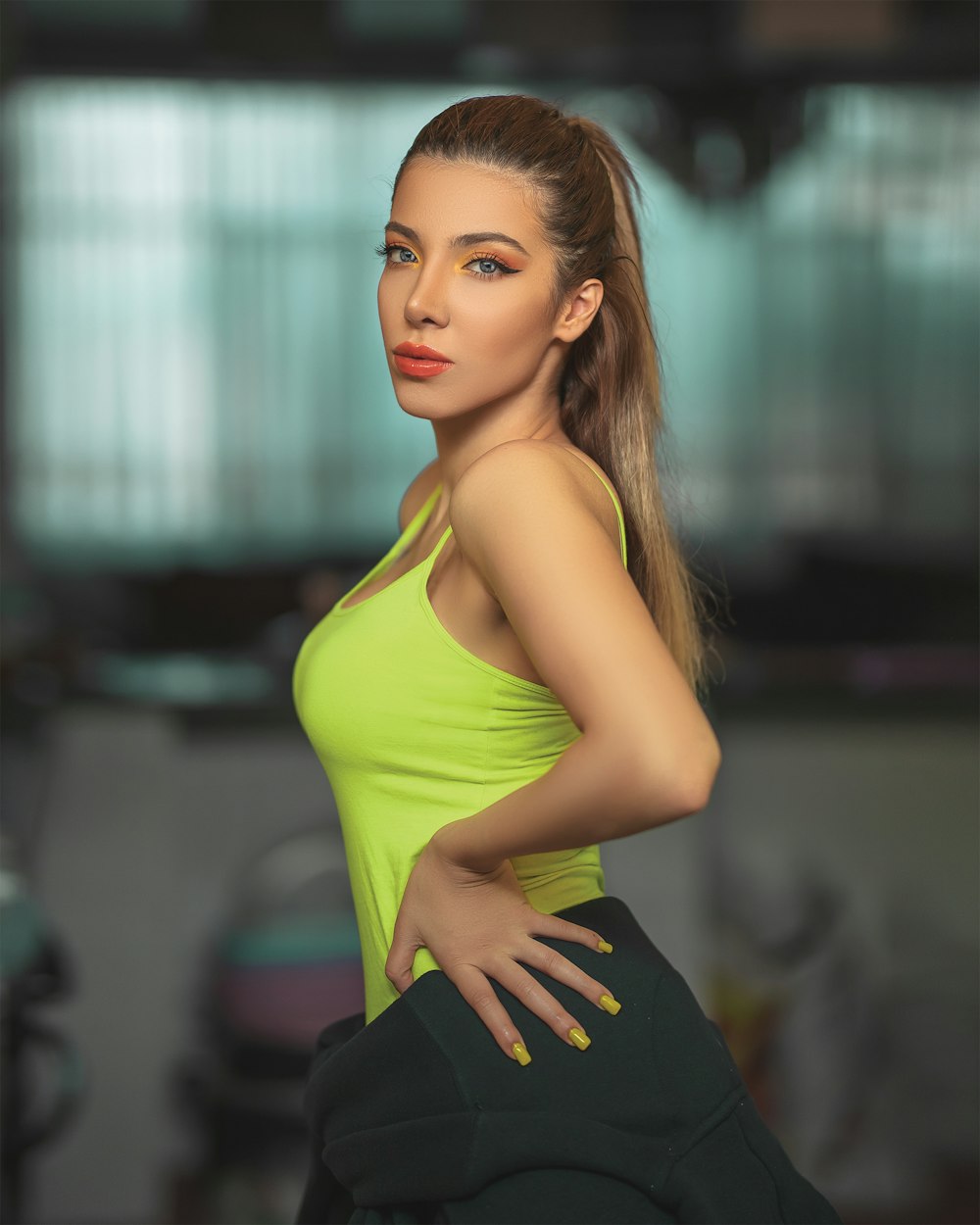 selective focus photography of woman wearing green tank top making pose