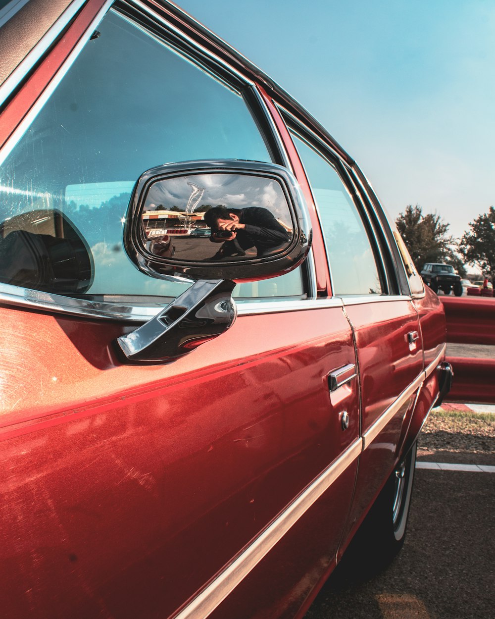 parked red sedan during daytime