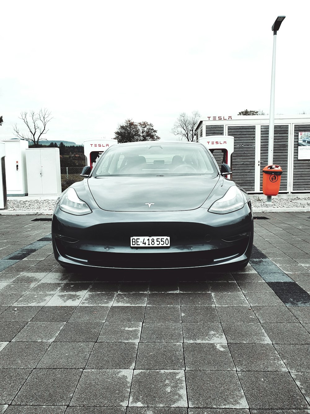 gray car on parking lot under clear sky during daytime