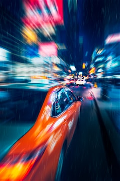 A vibrant rideshare car wrapped with colorful advertising graphics cruising through city streets.