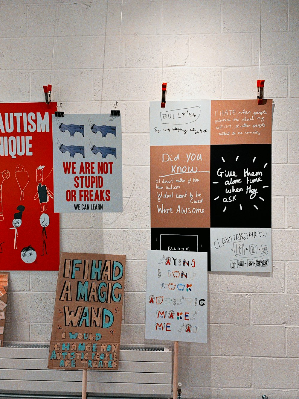 greetings cards hanged by a thread near white brick wall paint