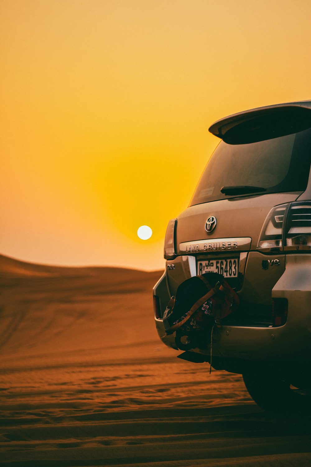 black Toyota Land Cruiser SUV on desert during golden hour