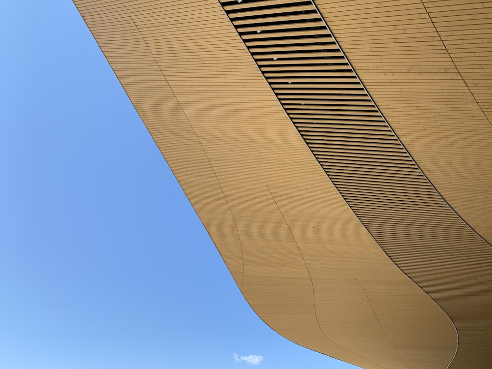 an airplane flying over a building with a sky background