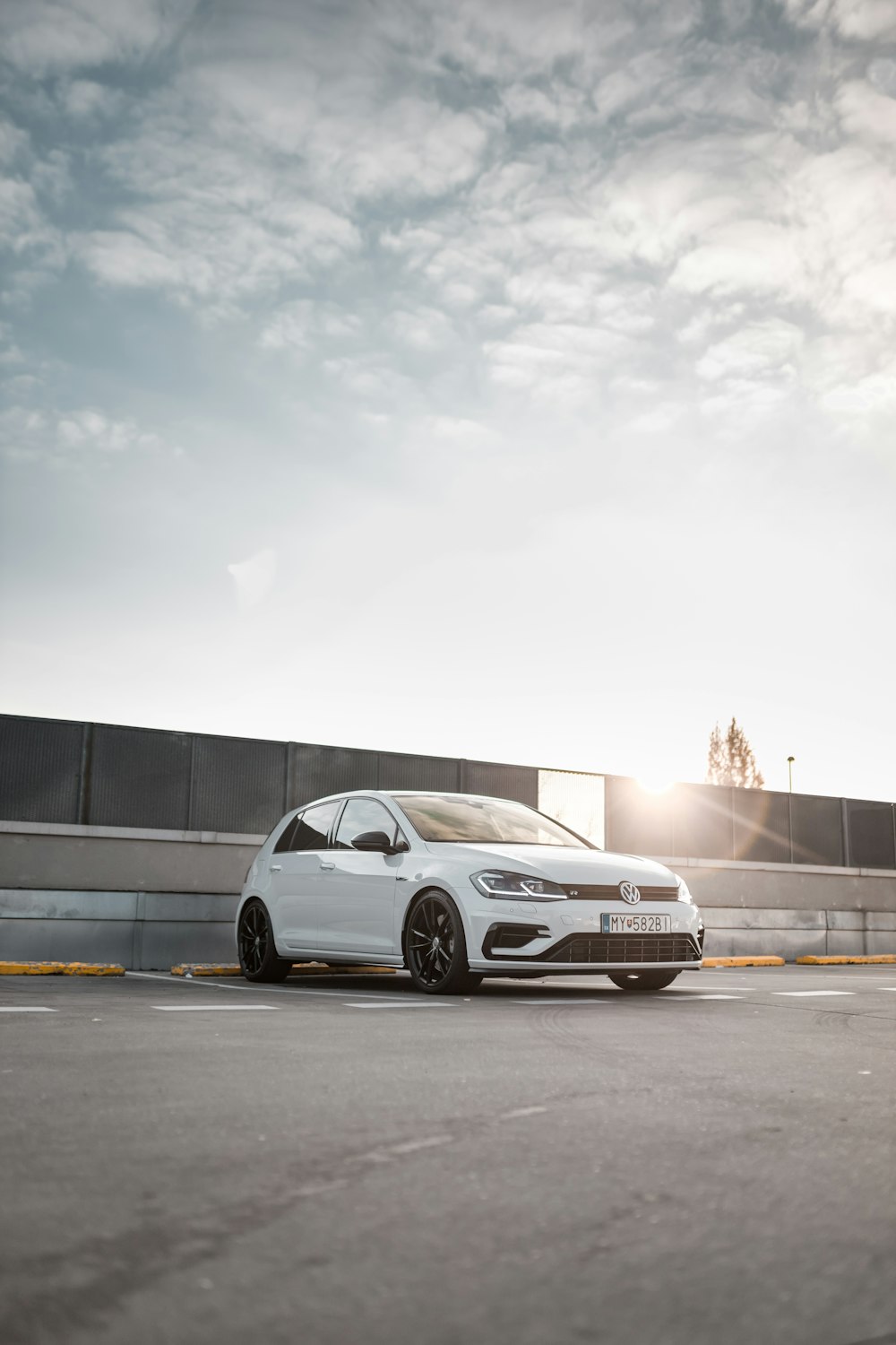 white 5-door hatchback under white clouds