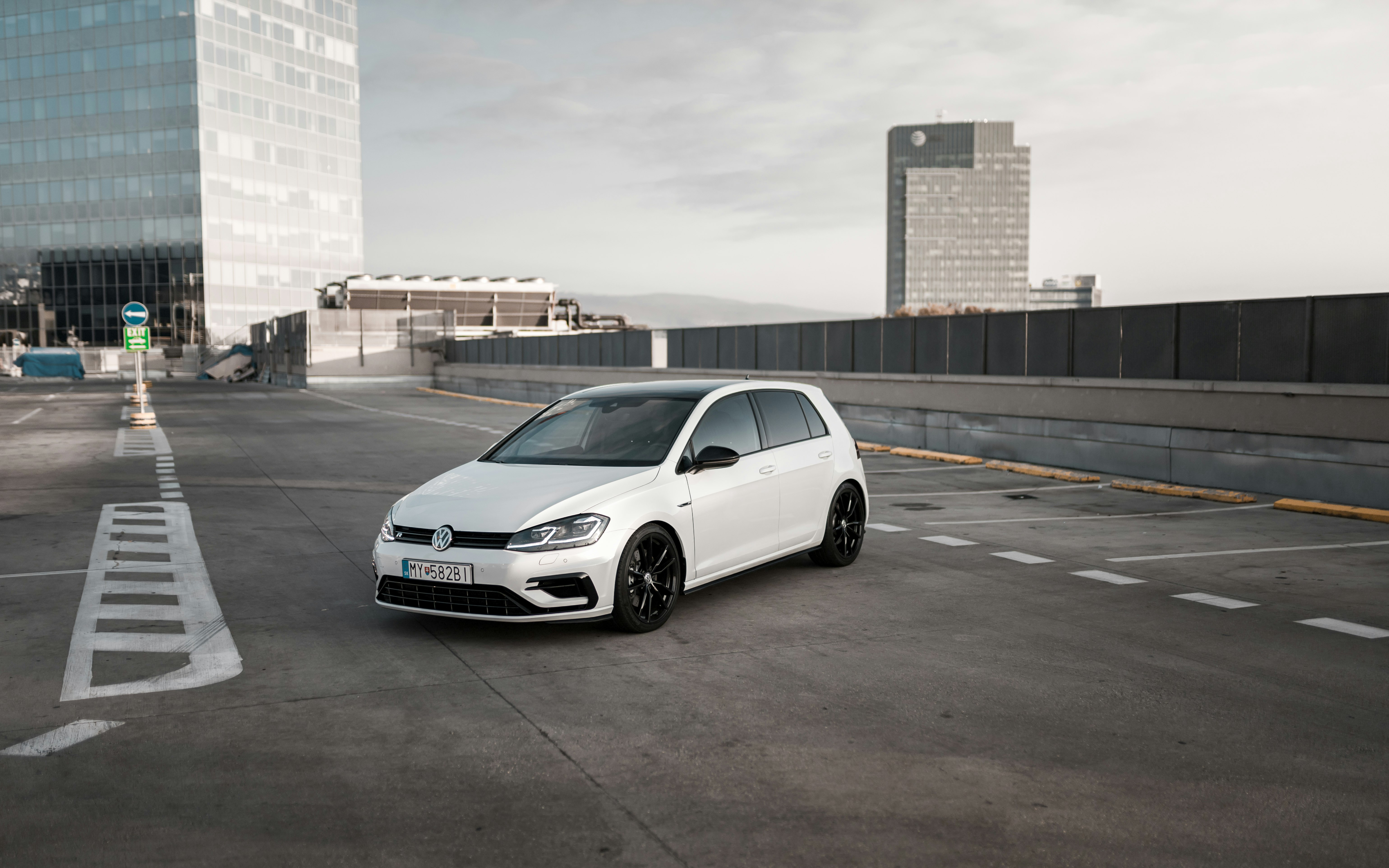 white Volkswagen 5-door hatchback on parking lot