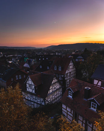 A snapshot of a peaceful village landscape at sunset with traditional houses