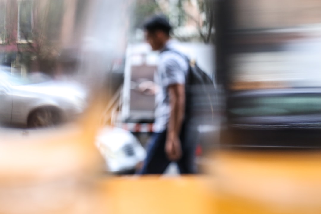 man walking on paved road