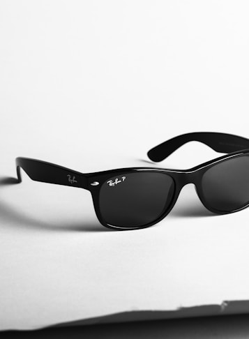 shallow focus photo of black Ray-Ban wayfarer sunglasses