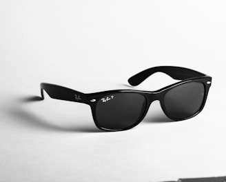 shallow focus photo of black Ray-Ban wayfarer sunglasses