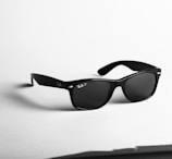 shallow focus photo of black Ray-Ban wayfarer sunglasses