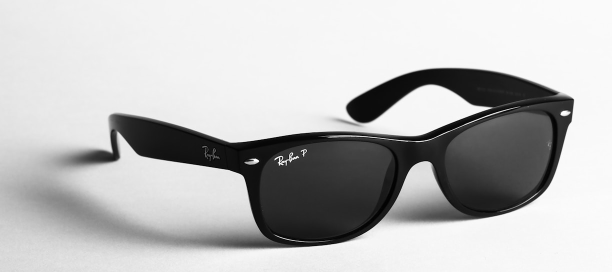 shallow focus photo of black Ray-Ban wayfarer sunglasses