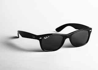 shallow focus photo of black Ray-Ban wayfarer sunglasses