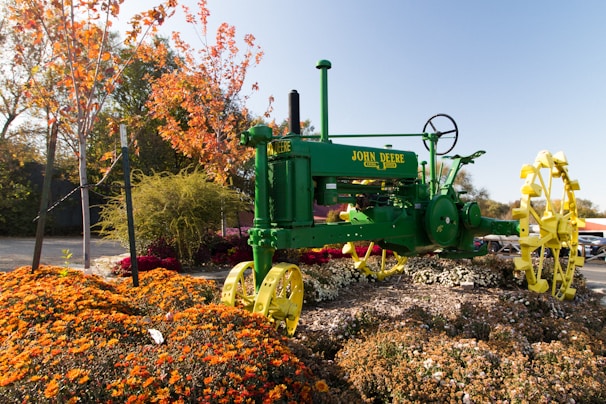 A vibrant John Deere tractor in a lush green field.