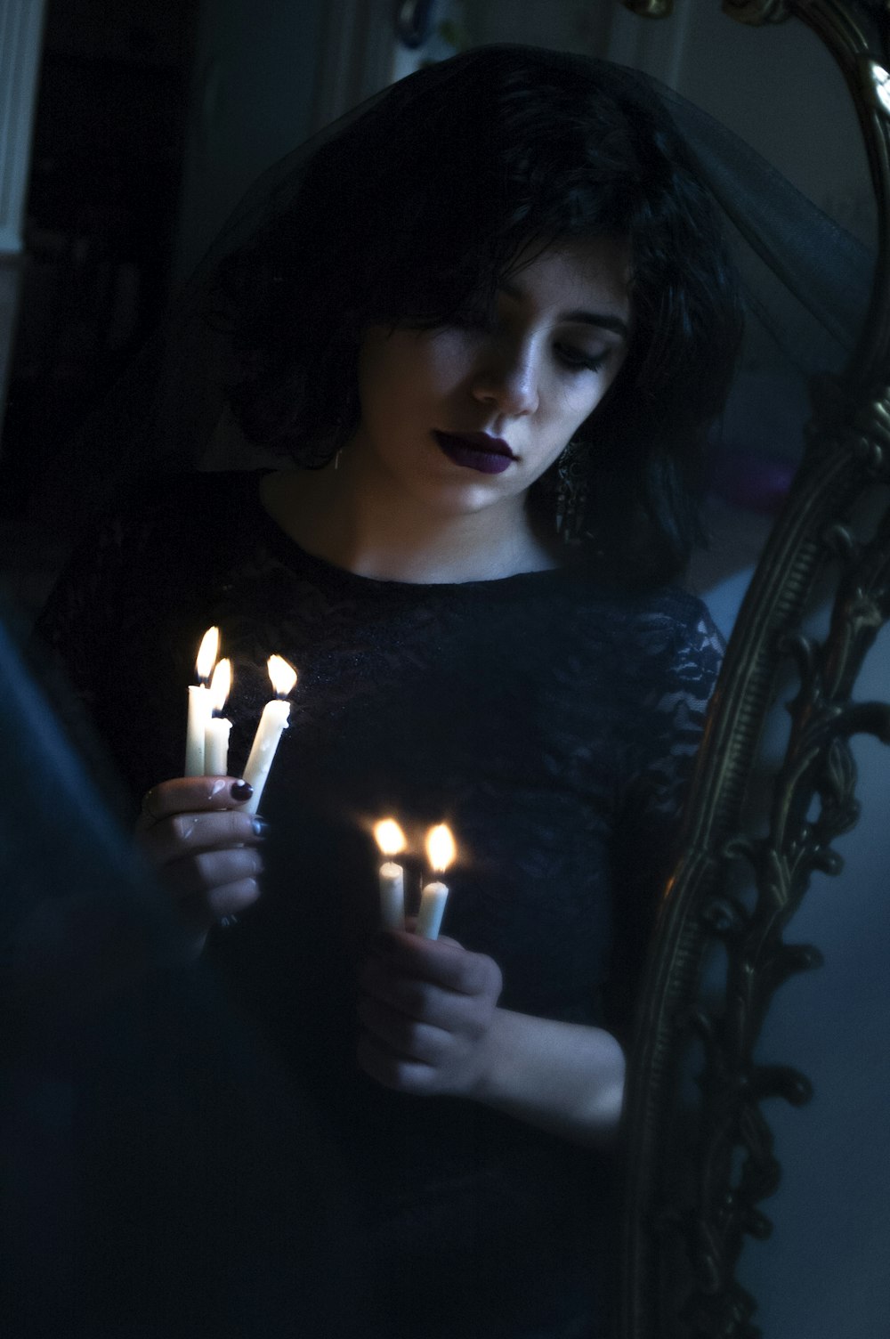 woman holding five white candles