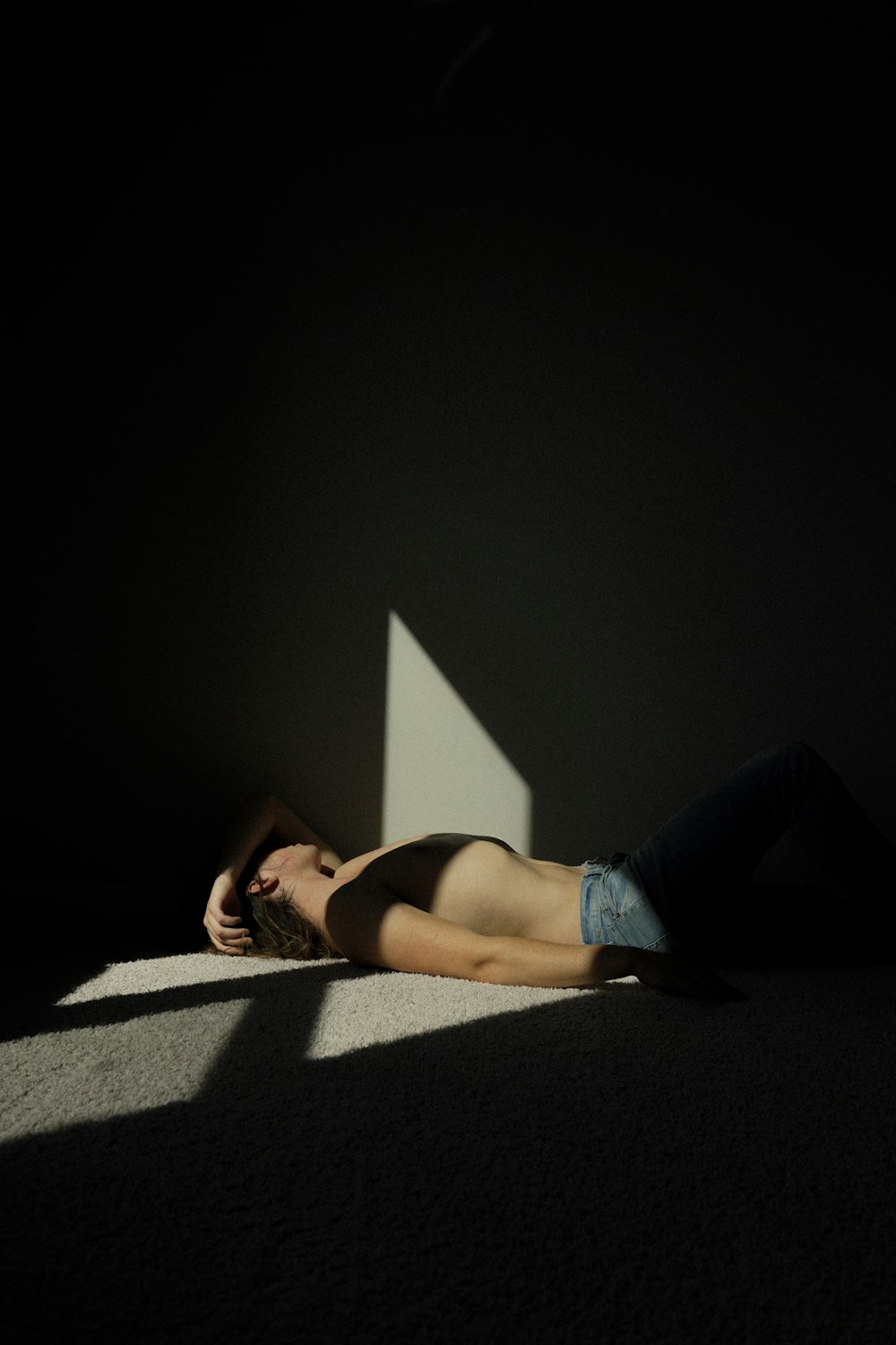 topless person lying on dimmed lighted room