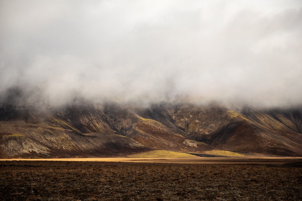 brown hills covered with clouds