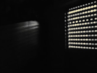 Bright room with horizontal blinds casting gentle shadows on the walls.