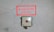 A cracked wall background with a red-bordered sign mounted above an emergency button. The sign reads 'IN CASE OF FIRE STOP AHU-1'.