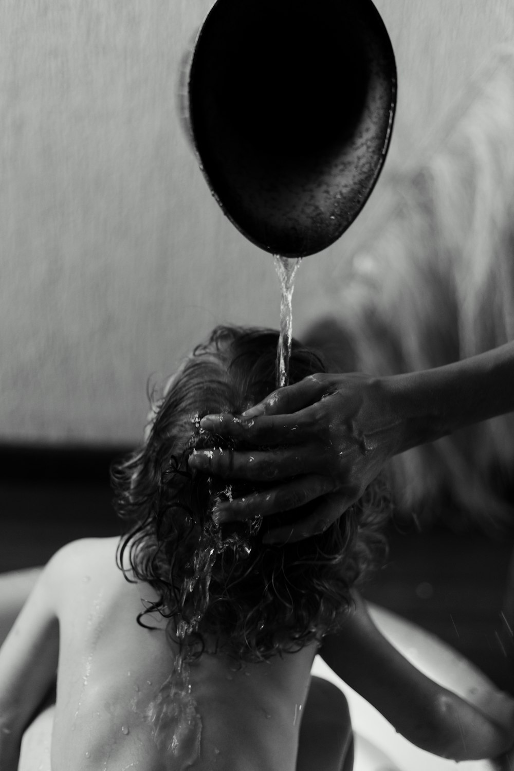 gray-scale photography of person taking a bath