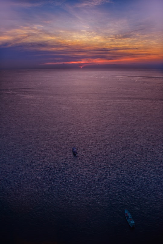 two boats on body of water under blue and orange sky in Phu Quoc Vietnam