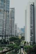 Modern residential buildings surrounded by green urban landscapes.