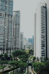 Modern urban buildings surrounded by lush greenery in a tropical setting