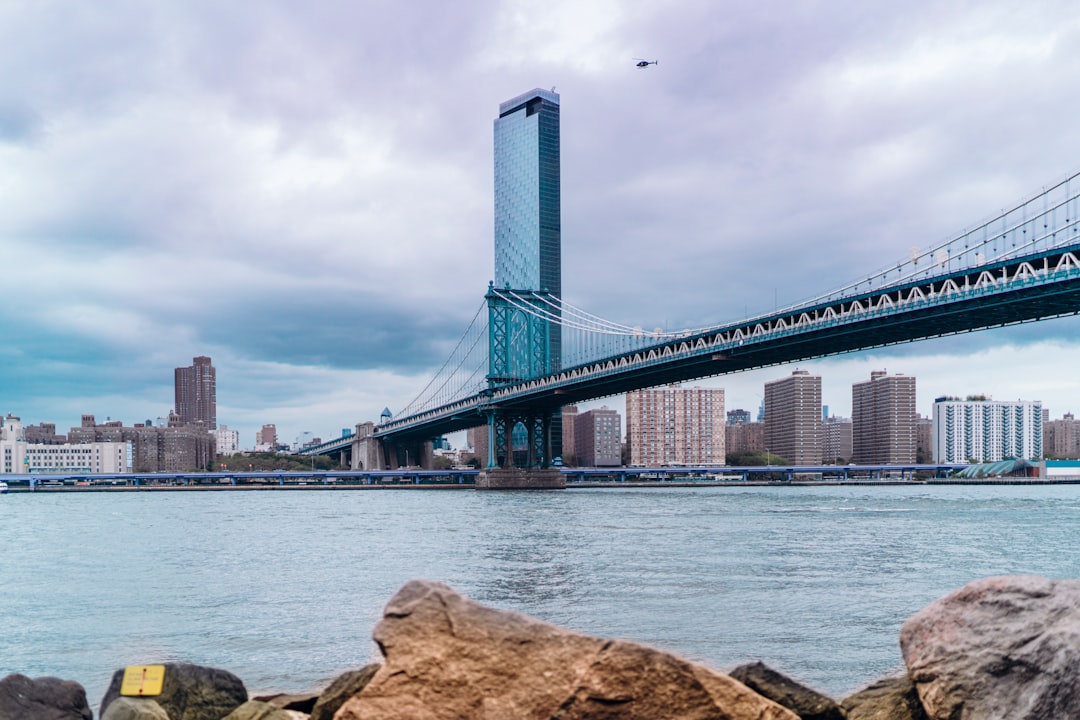 gray bridge under cloudy sky