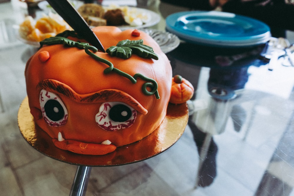 orange covered cake on table