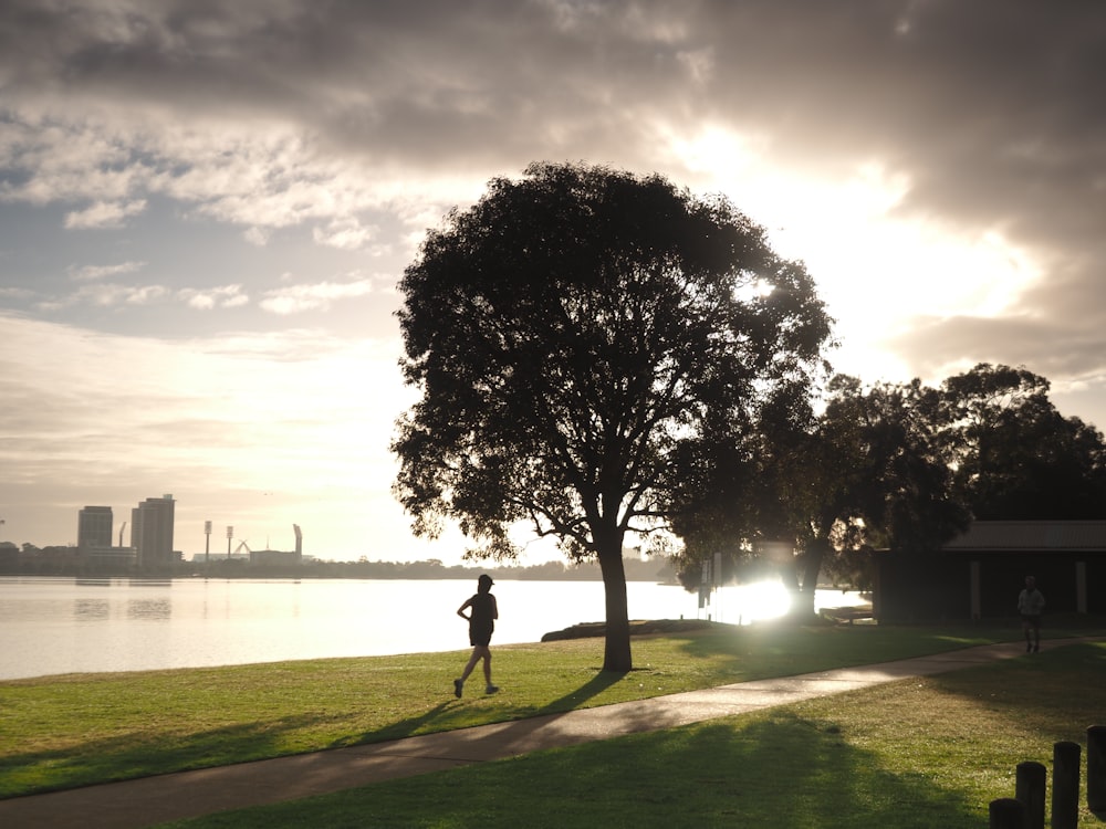 person running beside tree