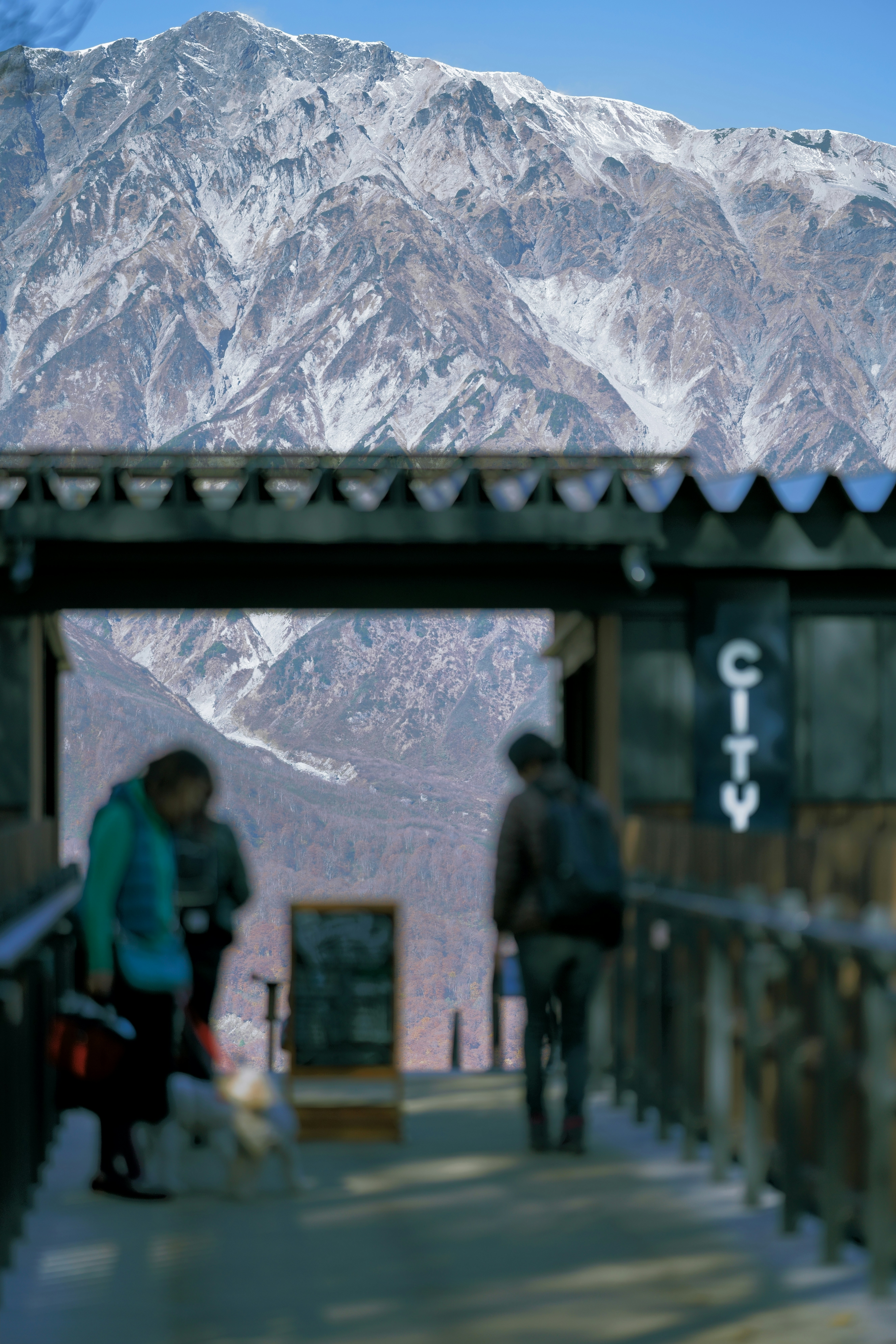 a couple of people standing on top of a snow covered slope
