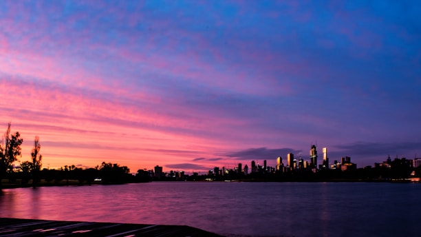 A vibrant sunset over the São Francisco River with the city of Petrolina in the background.