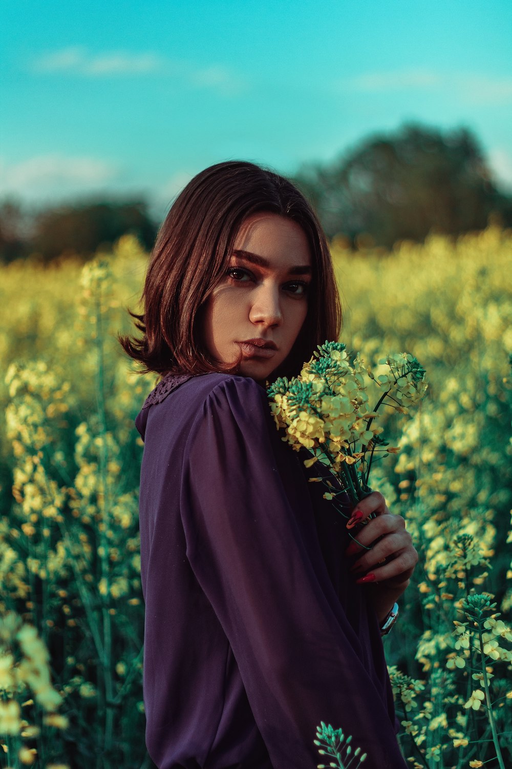 woman holding a bouquet of yellow flowers