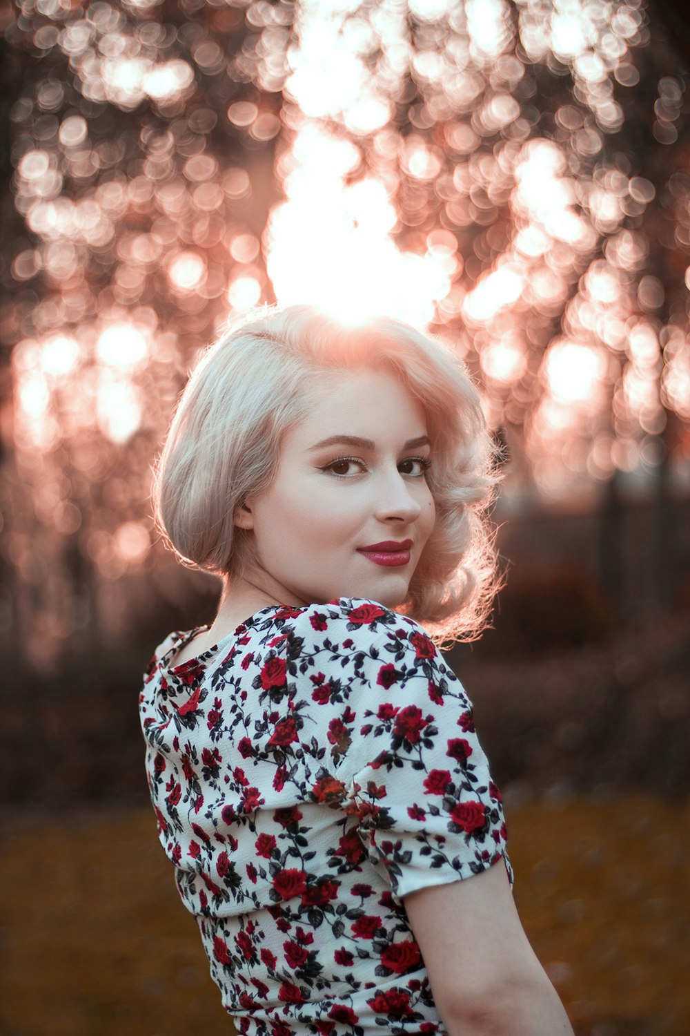 woman in white and red floral short-sleeved shirt