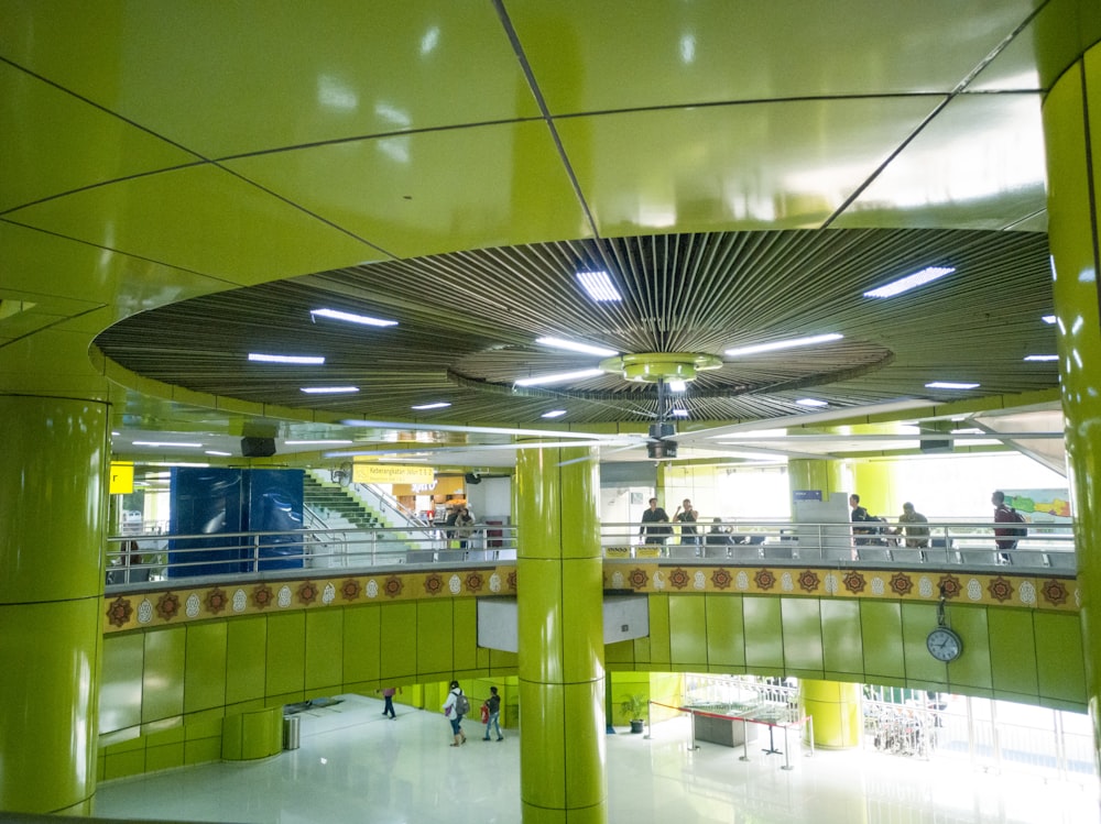 people walking inside building with chandelier