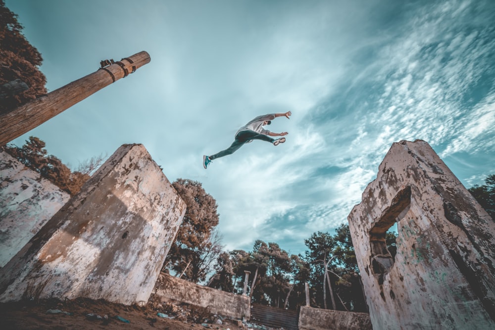 man jumping off next concrete wall