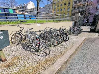 A row of refurbished bicycles lined up outdoors on a sunny day.