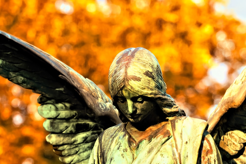 shallow focus photo of angel statue