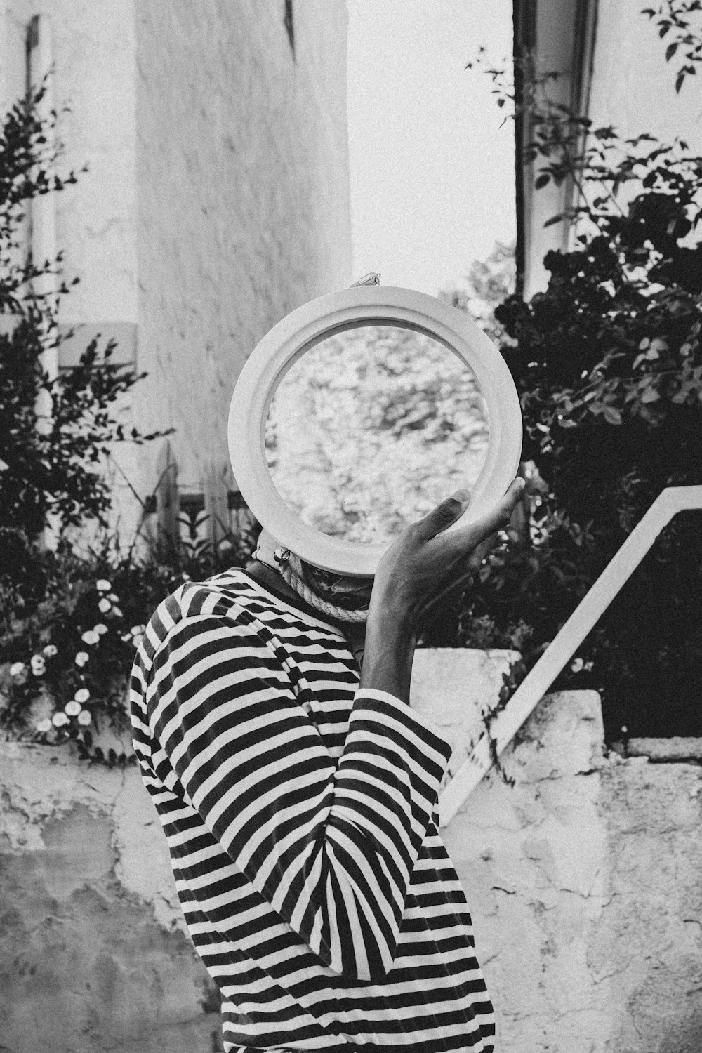 greyscale photography of person holding round decor