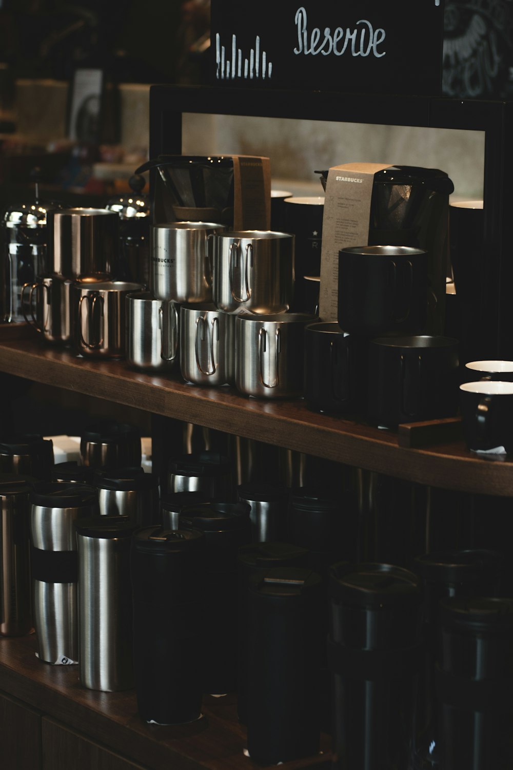 shallow focus photo of stainless steel containers on brown wooden surface